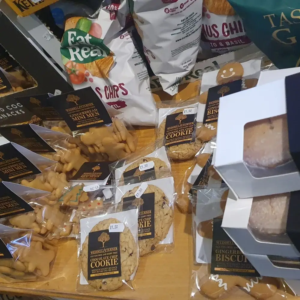 Farm shop snack display with biscuits, cookies, crisps and sweet treats at Yare Valley