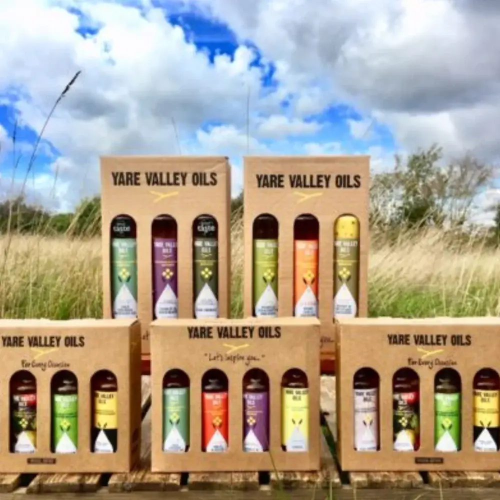 Yare Valley Oils gift boxes displayed outdoors, showing a selection of cold pressed rapeseed oils, infused oils and dressings.